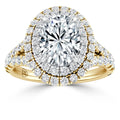 Gold ring with a large oval diamond center, double halo, and pavé diamond accents on the band.