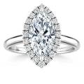 Marquise-cut diamond ring with a halo of smaller diamonds on a sleek white gold band, viewed from above.