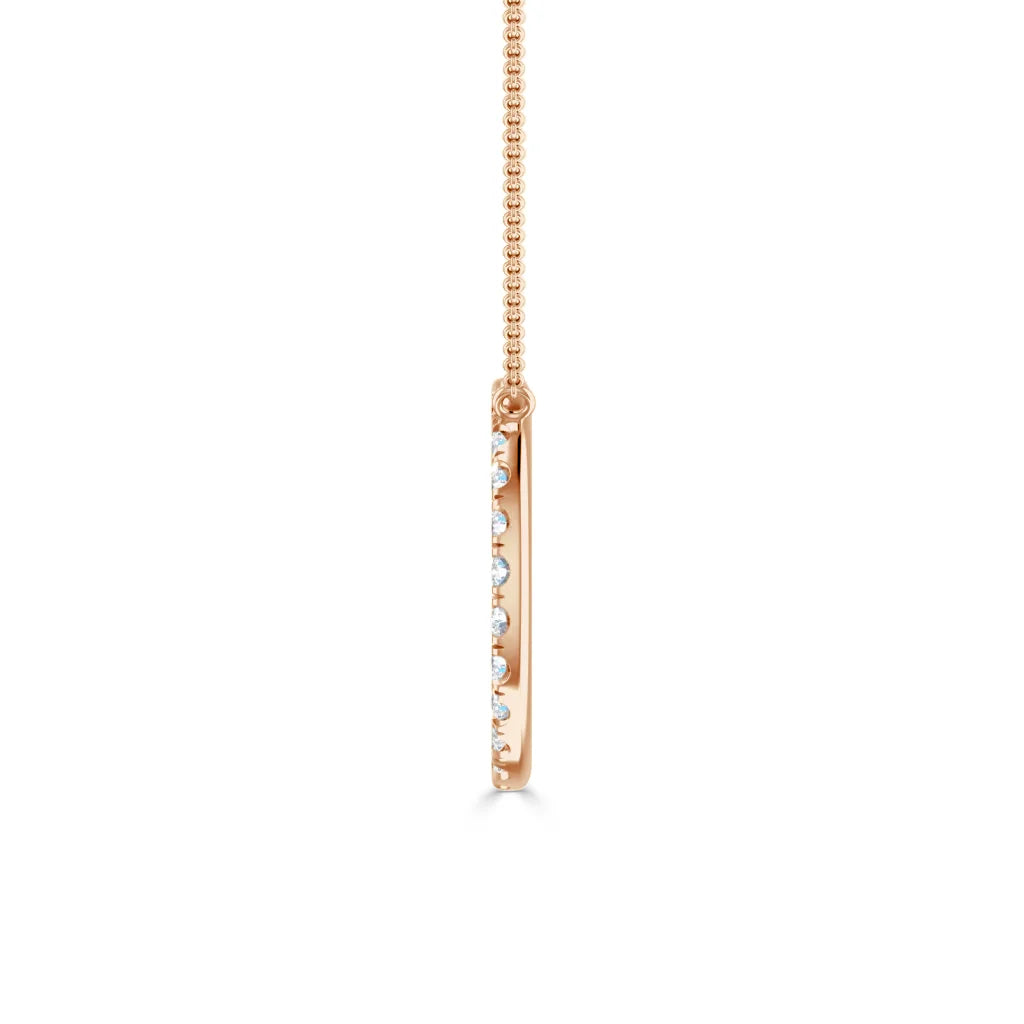 Side view of a thin rose gold pendant necklace with embedded small round diamonds on a box chain.