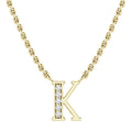 Gold chain necklace with a K pendant, half encrusted with small clear gemstones, on a white background.