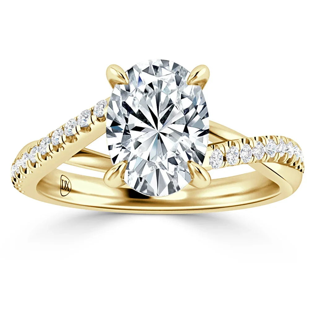 Gold ring with a large oval diamond center stone and a band accented with small round diamonds.