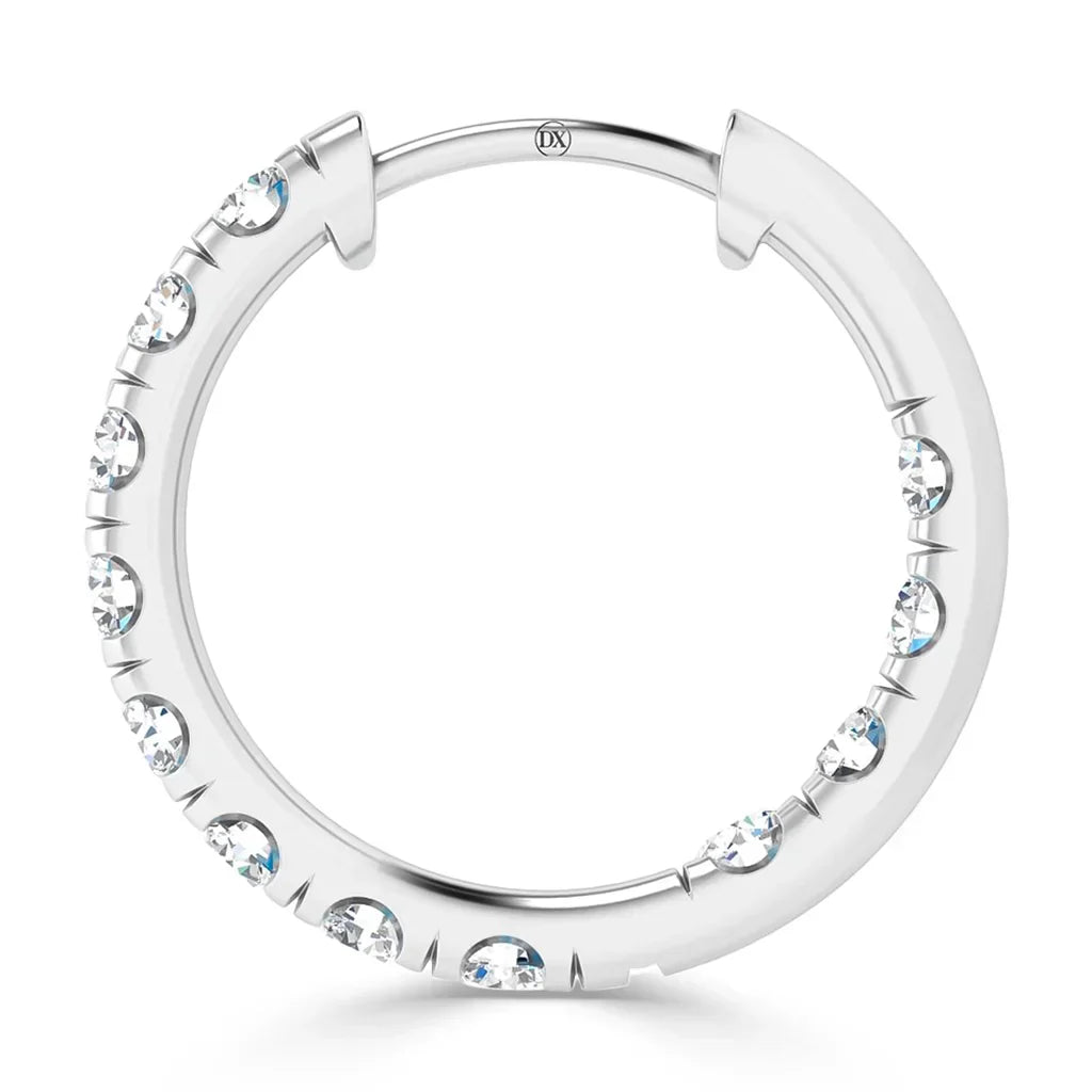 A silver hoop earring adorned with evenly spaced, round, clear gemstones around its outer edge.