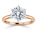 Rose gold ring with a large round diamond solitaire held by six prongs, shown on a white background.