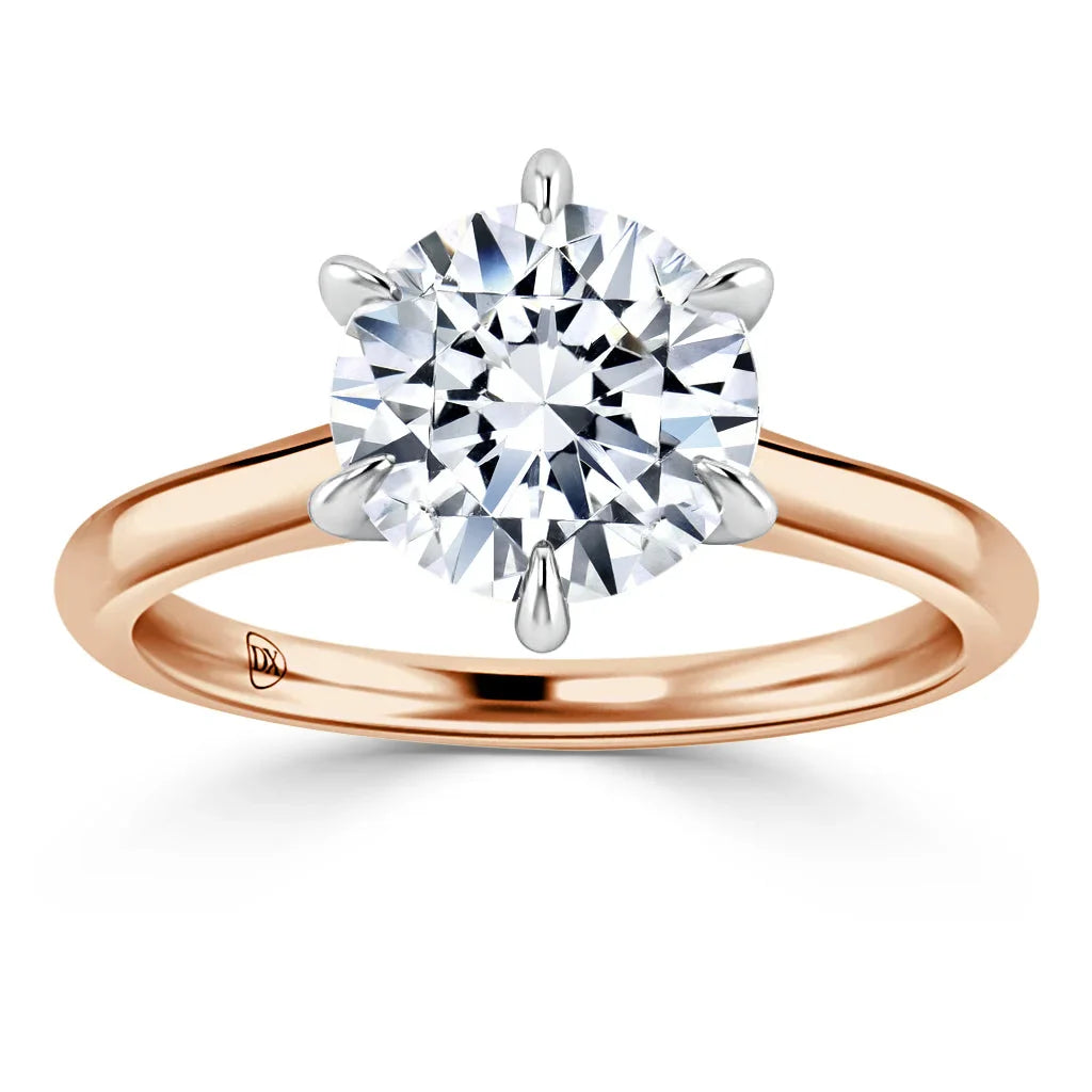 Rose gold ring with a large round diamond solitaire held by six prongs, shown on a white background.