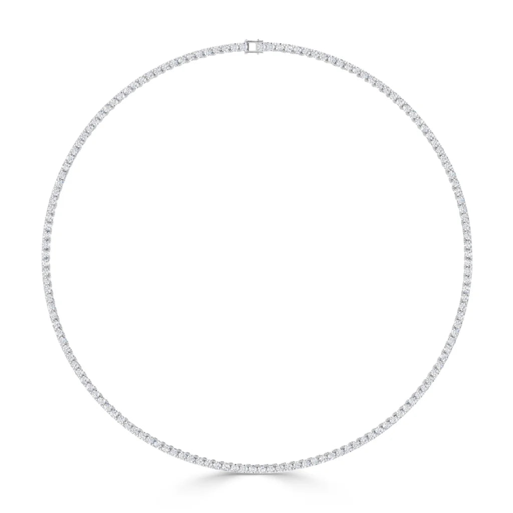 A delicate, circular diamond tennis necklace with small, evenly spaced diamonds set in white metal.