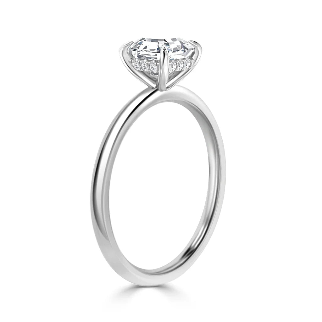 Silver ring with a round solitaire diamond in a prong setting, viewed from the side on a white background.