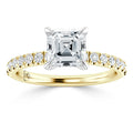 Gold ring with an Asscher-cut diamond center stone and small round diamonds on the band.
