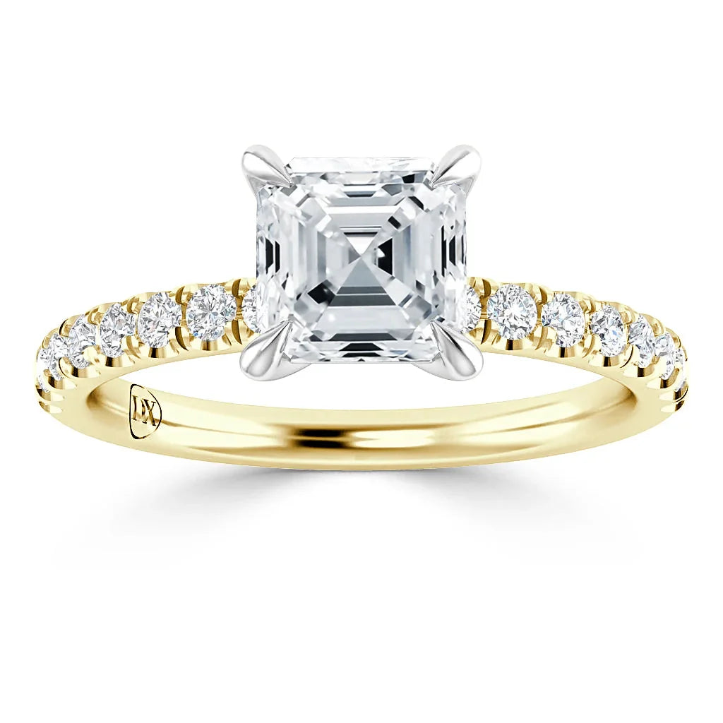 Gold ring with an Asscher-cut diamond center stone and small round diamonds on the band.