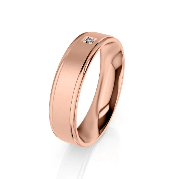 A rose gold band ring with a single small diamond set into the center of the smooth, polished surface.