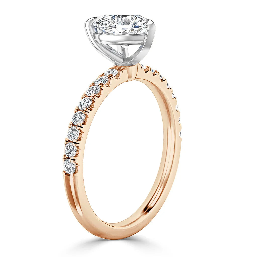 Gold ring with round diamonds on the band and a large solitaire diamond in a white gold prong setting.