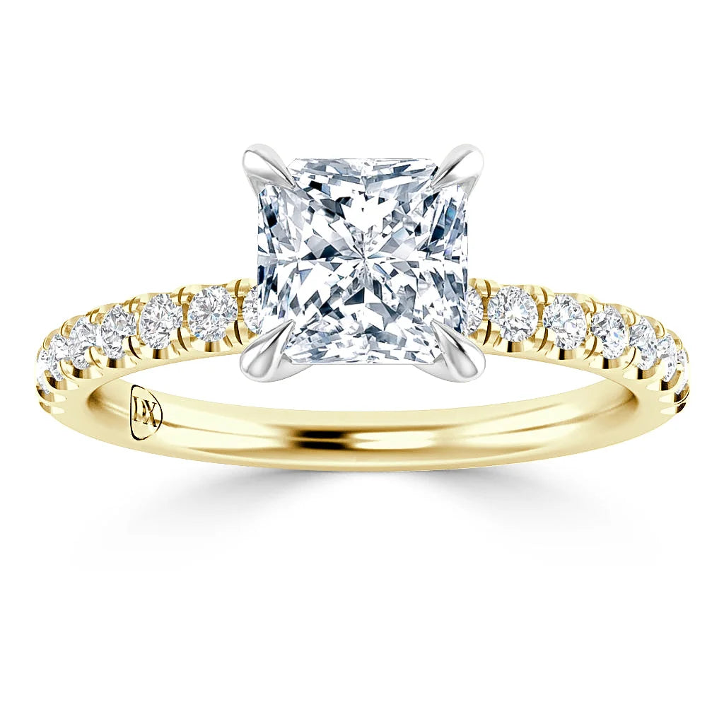A gold ring with a square-cut diamond center and small round diamonds along the band.