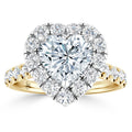 A gold ring with a heart-shaped diamond center, surrounded by round diamonds and a diamond-accented band.