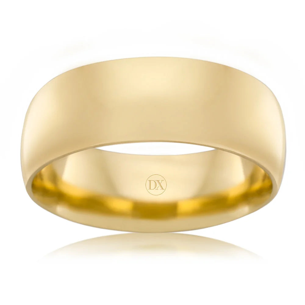 A plain, polished yellow gold ring with a smooth surface and DX engraved inside the band.