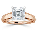 A rose gold ring with a large square-cut diamond set in a four-prong white gold setting.